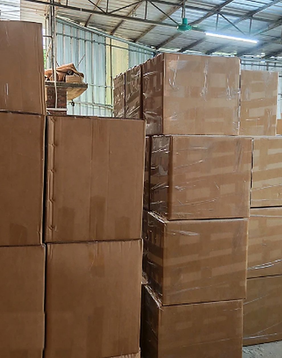 Stacked cartons of finished WanHu orders ready for dispatch in the Qingyuan warehouse